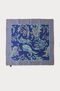 Light blue silk men's scarf with decorative pattern, viewed from above