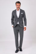 Front view of an anthracite drop 7 suit with two-button jacket and patch pockets on a model