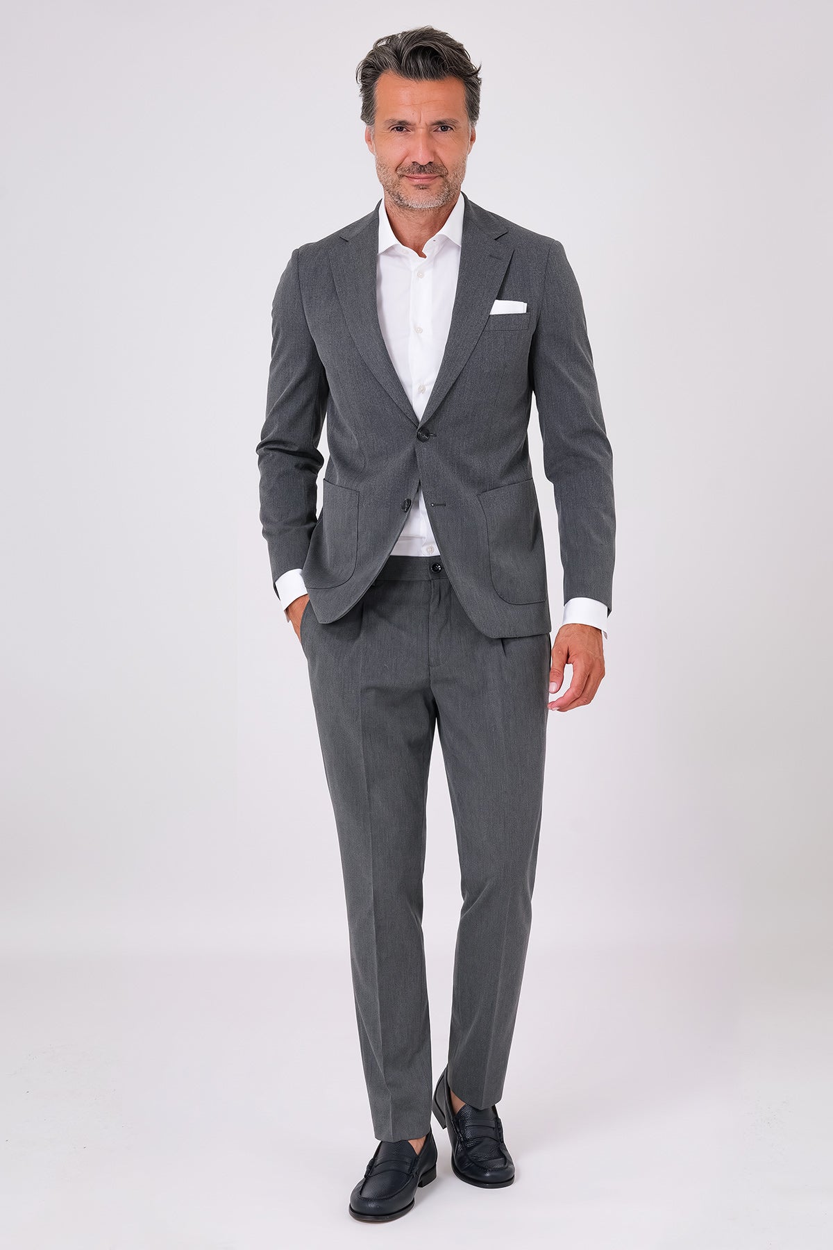 Front view of an anthracite drop 7 suit with two-button jacket and patch pockets on a model