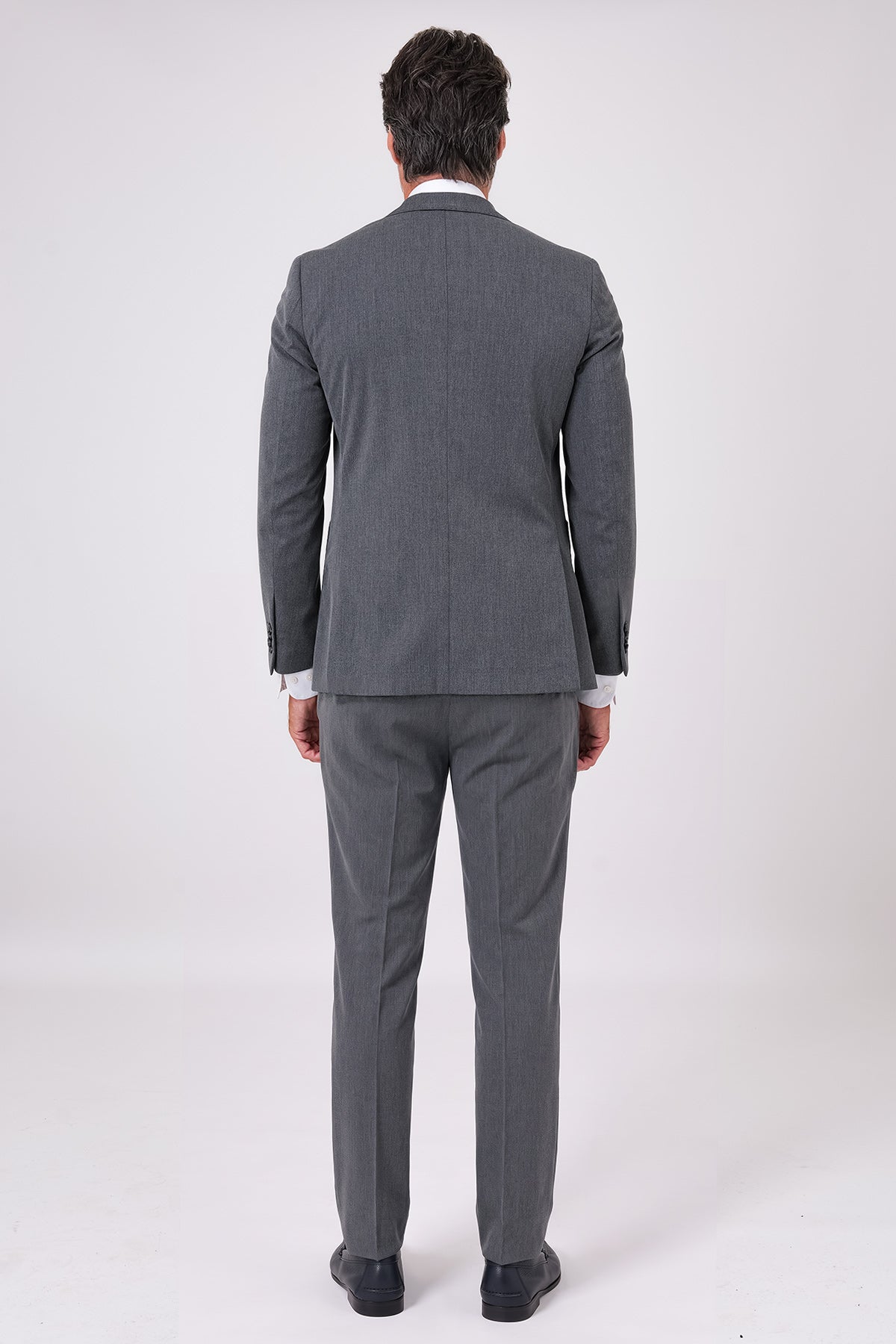 Back view of the charcoal two-piece suit on a model