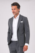Front view of a charcoal drop 7 suit on a model, with a two-button single-breasted jacket and patch pockets