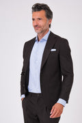 Front view of a dark brown suit with a single-breasted jacket and patch pockets on a model