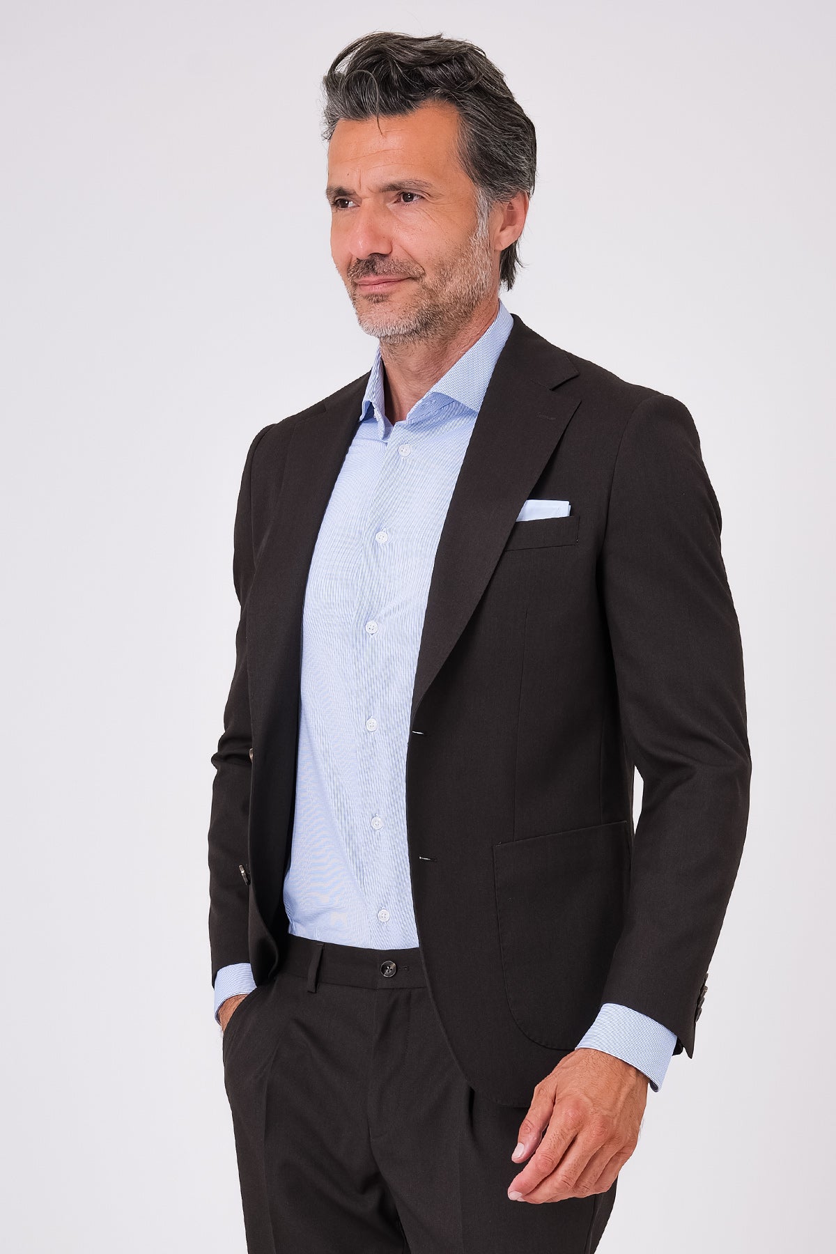 Front view of a dark brown suit with a single-breasted jacket and patch pockets on a model