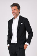 Black suit with two-button jacket and patch pockets on a model, front view