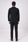 Rear view of the black two-piece suit with jacket and trousers on a model