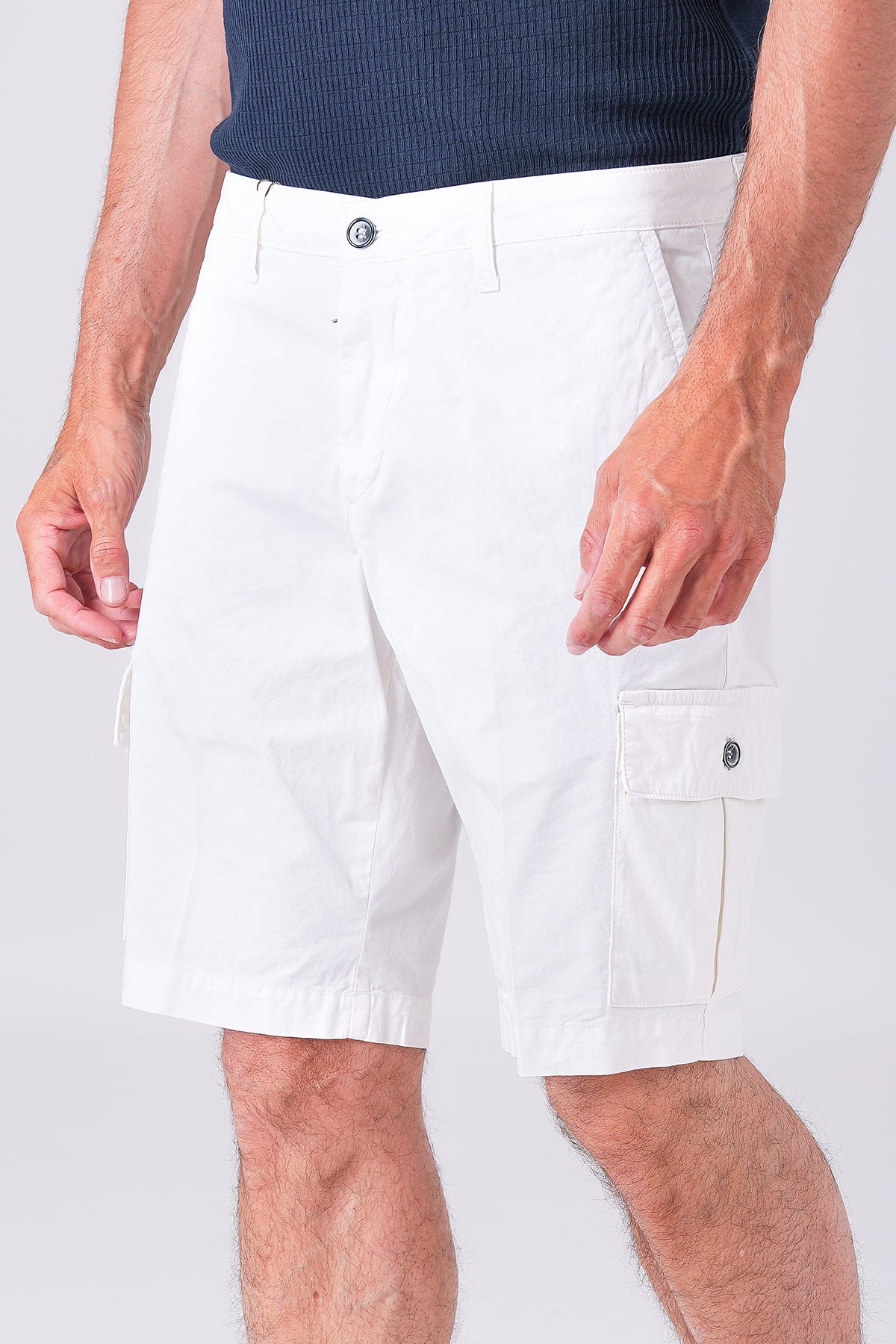 Lightly stretchy cotton cargo Bermuda shorts in a creamy color, front view