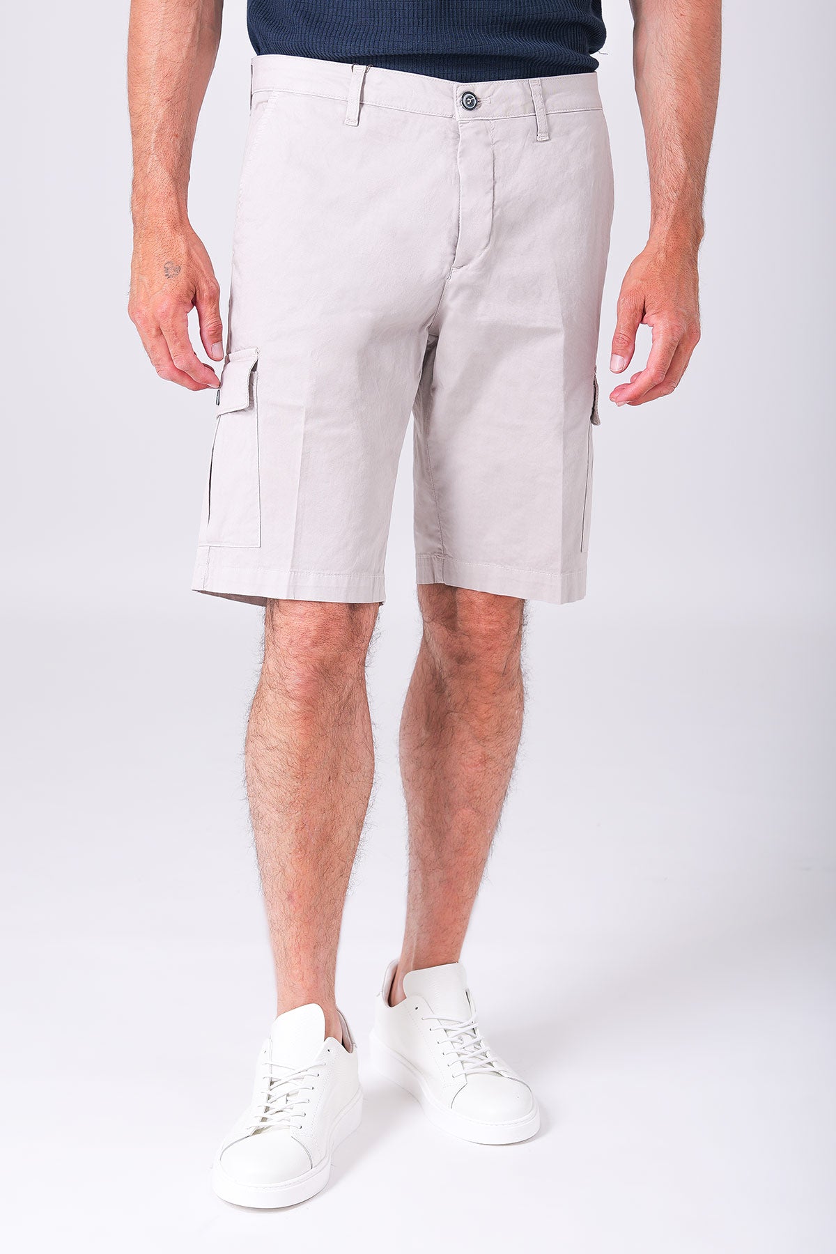 Front view of sandy beige stretch cotton cargo Bermuda shorts