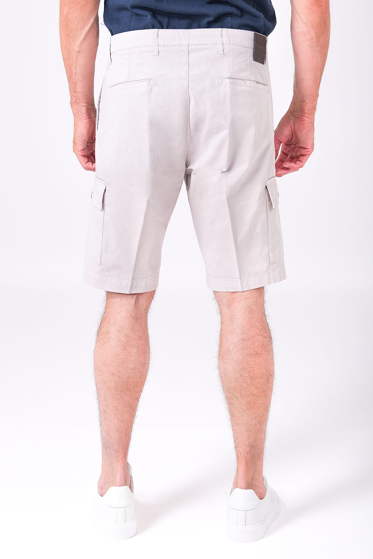 Back view of sandy beige cotton stretch cargo Bermuda shorts