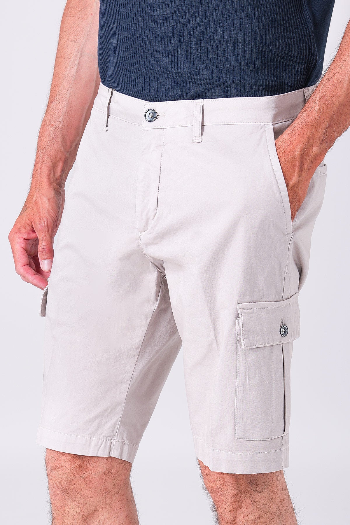 Cotton blend cargo shorts in sand with a close-up of the technical details