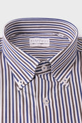 Close-up of the button-down collar and buttons on a striped cotton shirt