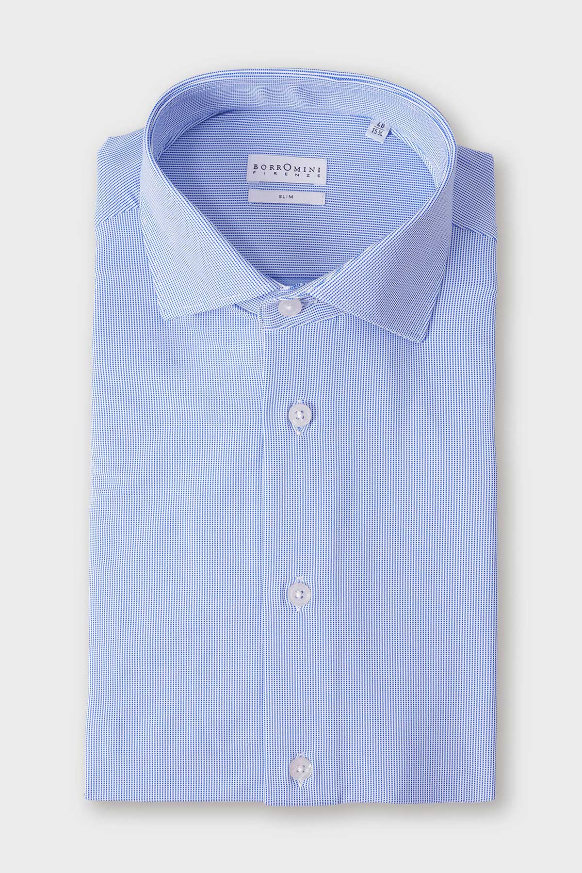 Folded light blue shirt with a spread collar and small, spaced geometric motifs