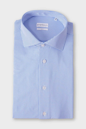 Folded light blue shirt with a spread collar and small, spaced geometric motifs