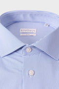 Close-up of the spread collar and small geometric motifs on the light blue shirt