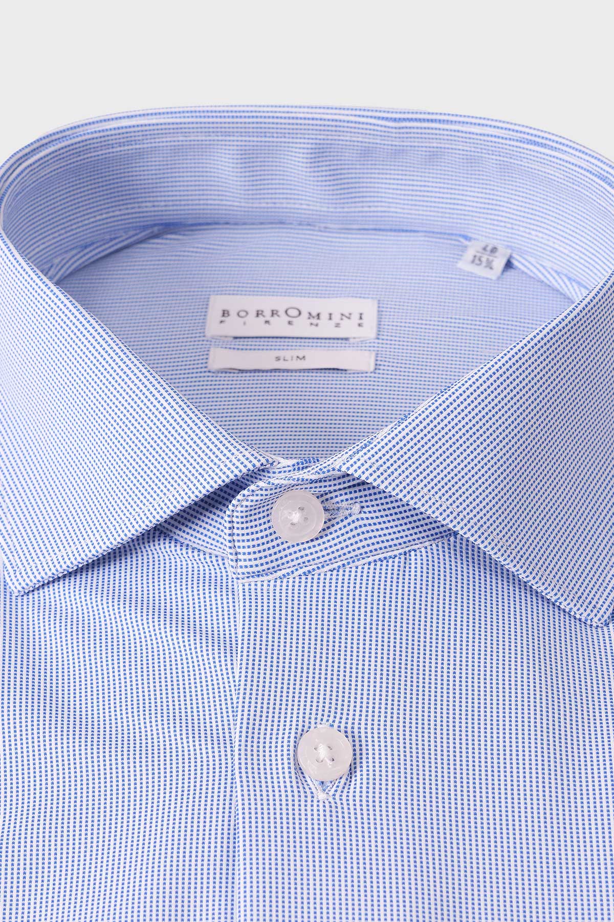 Close-up of the spread collar and small geometric motifs on the light blue shirt