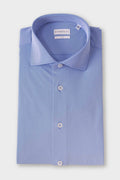 Folded shirt in denim blue with a spread collar and a dense geometric micro-pattern