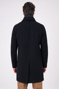 Vista posteriore del cappotto blu navy indossato, con spacco centrale