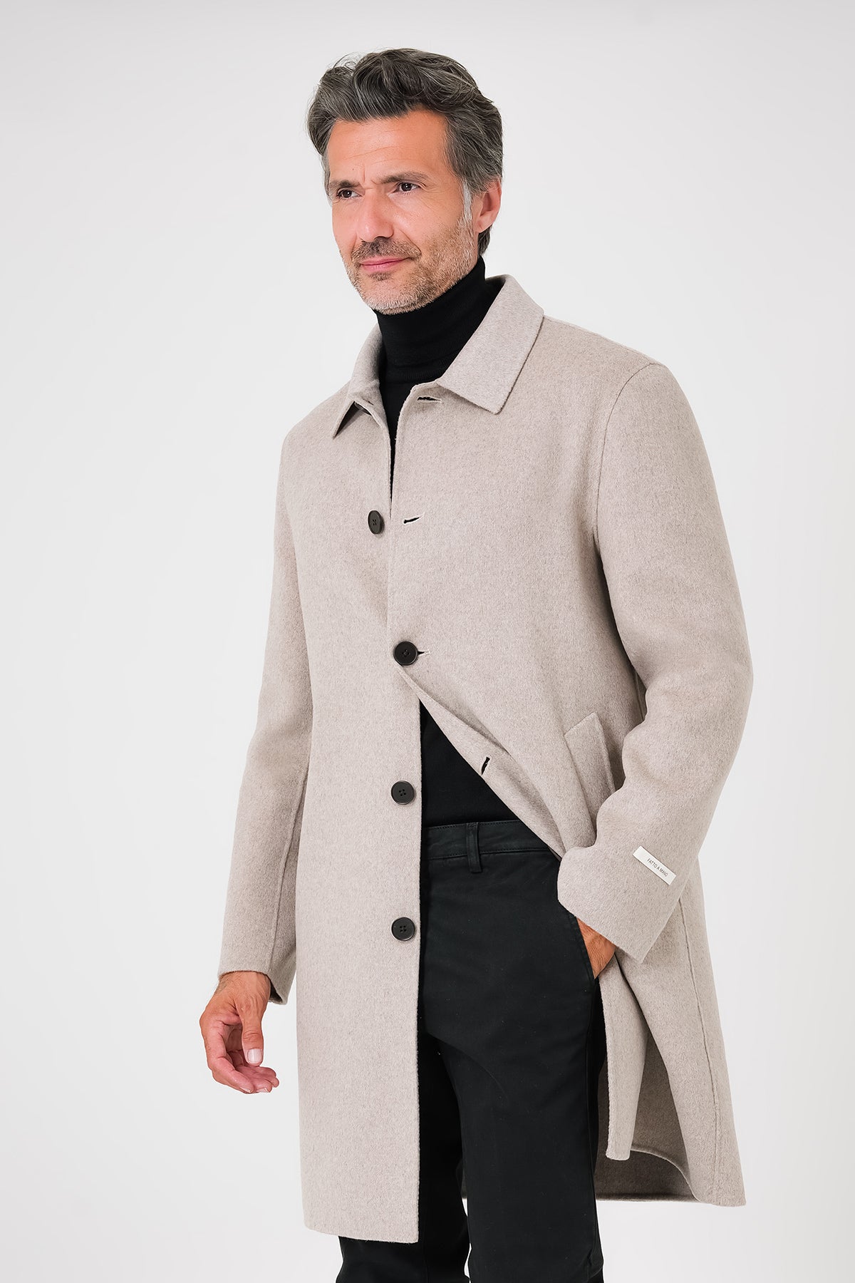 Front view of a beige double-faced coat with a shirt collar and visible buttons on a model