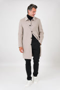 Front view of the beige coat with shirt collar and buttons, on a model