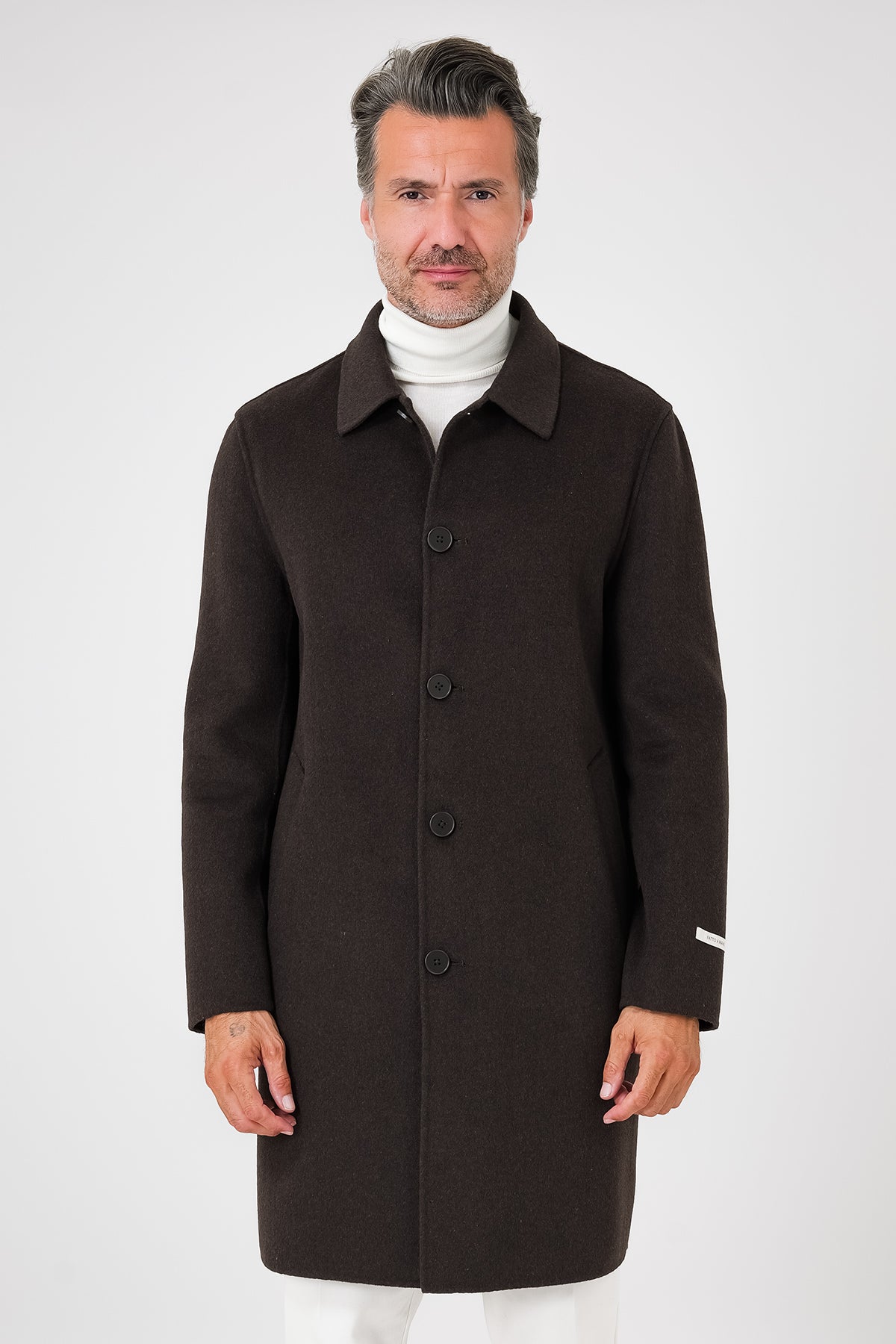 Front view of the dark brown coat with shirt collar and front buttons, on a model