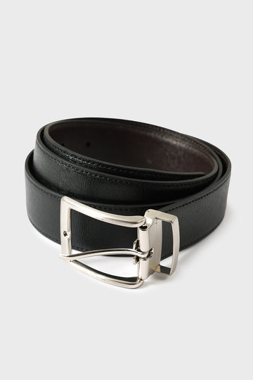 Rolled reversible leather belt, showing the black side and silver-tone buckle