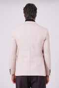 Rear view of the beige jacket on a model