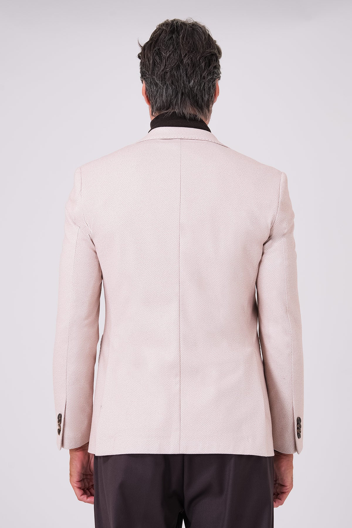 Rear view of the beige jacket on a model