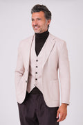 Beige single-breasted jacket with patch pockets on a model, front view