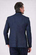 Back view of the blue jacket on a model with back vents