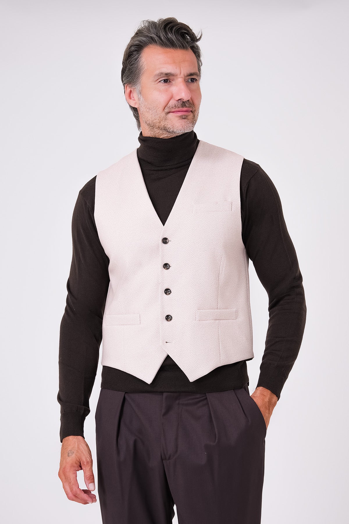 Front view of beige herringbone waistcoat on a model