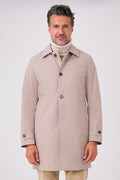 Front view of a beige raincoat with a shirt collar and button fastening on a model