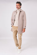 Front view of beige raincoat with shirt collar, worn open on a model