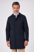 Navy blue raincoat with shirt collar and button fastening on a model, front view