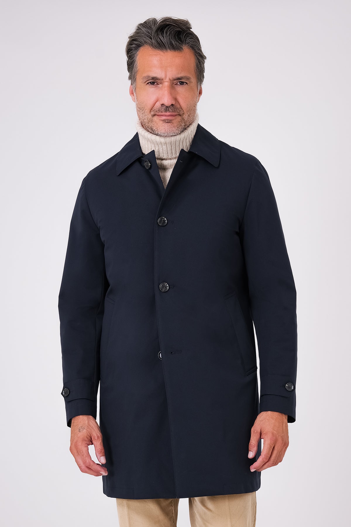 Navy blue raincoat with shirt collar and button fastening on a model, front view