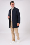 Front view of a navy blue raincoat with a shirt collar on a model