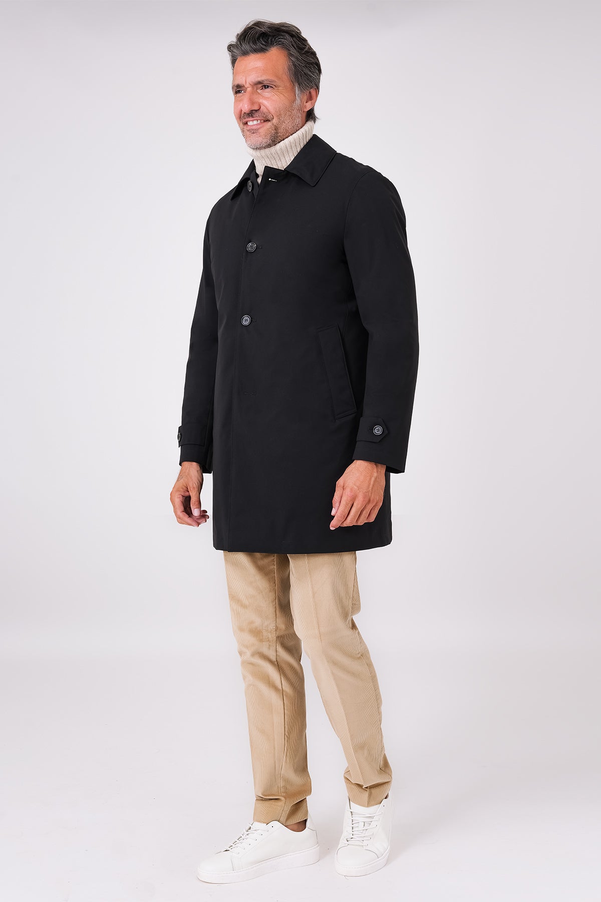 Black raincoat with a shirt collar and button fastening on a model