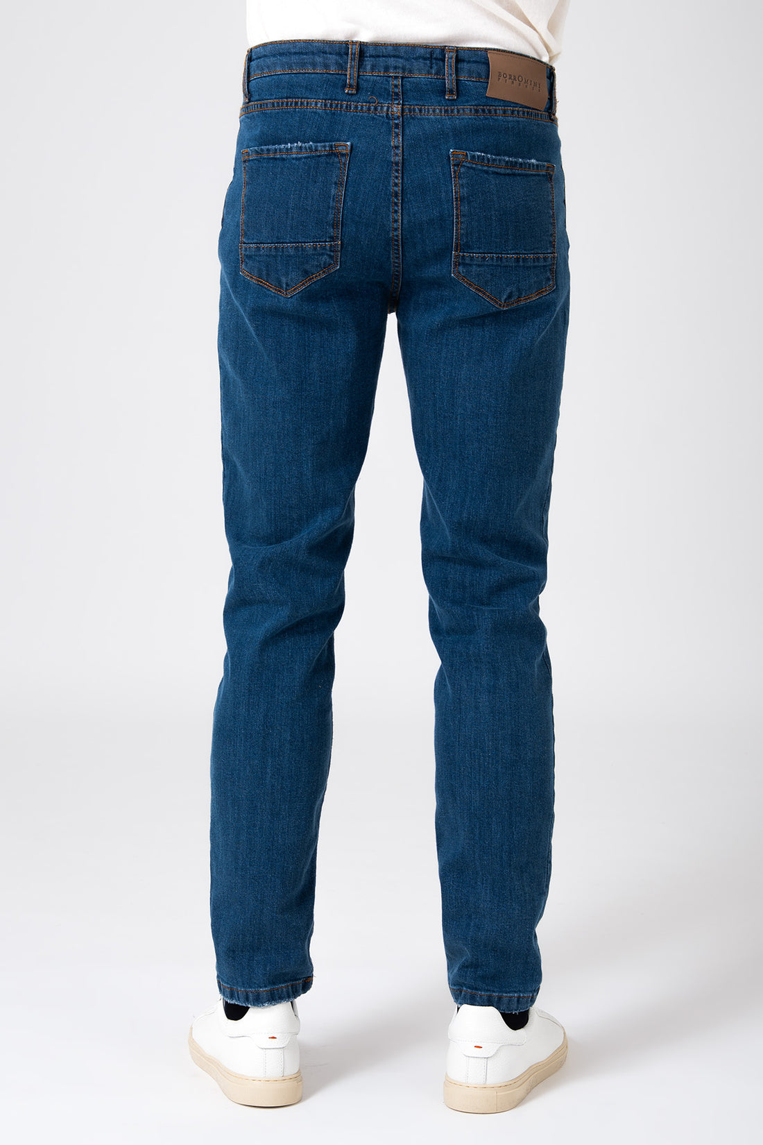 Man wearing dark denim five pocket jeans front view