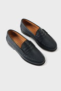 Pair of classic blue leather loafers with a saddle strap, high-angle three-quarter view