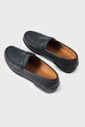 Elevated three-quarter view of classic blue leather loafers