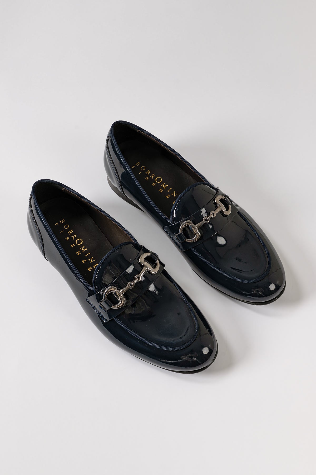 Patent leather penny loafers in blue, side view