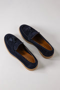 Front view of blue suede loafers with tassels