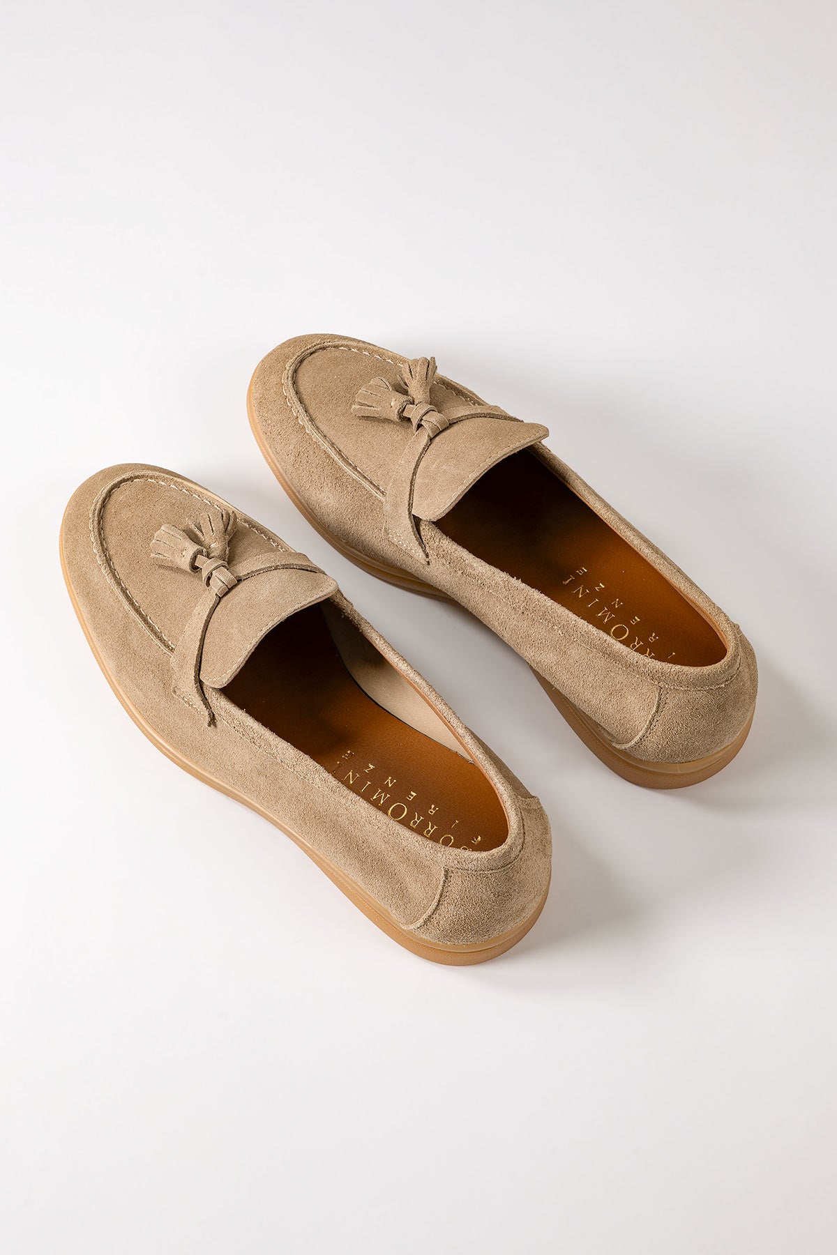 Front view of blue suede loafers with tassels