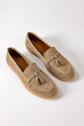 Side view of blue suede loafers with tassels