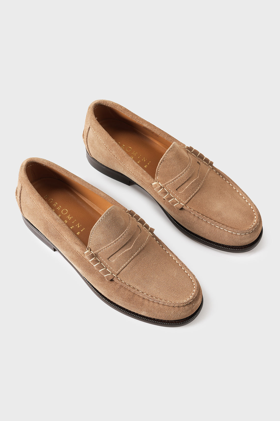 Top view of men's suede loafers with classic penny strap