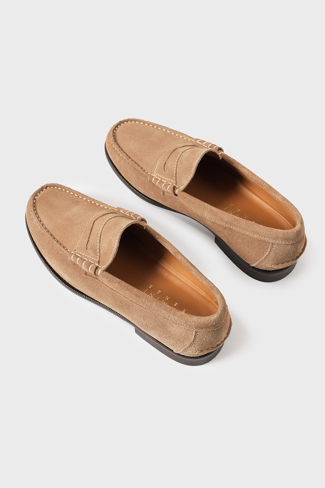 Top view of men's suede loafers with classic penny strap