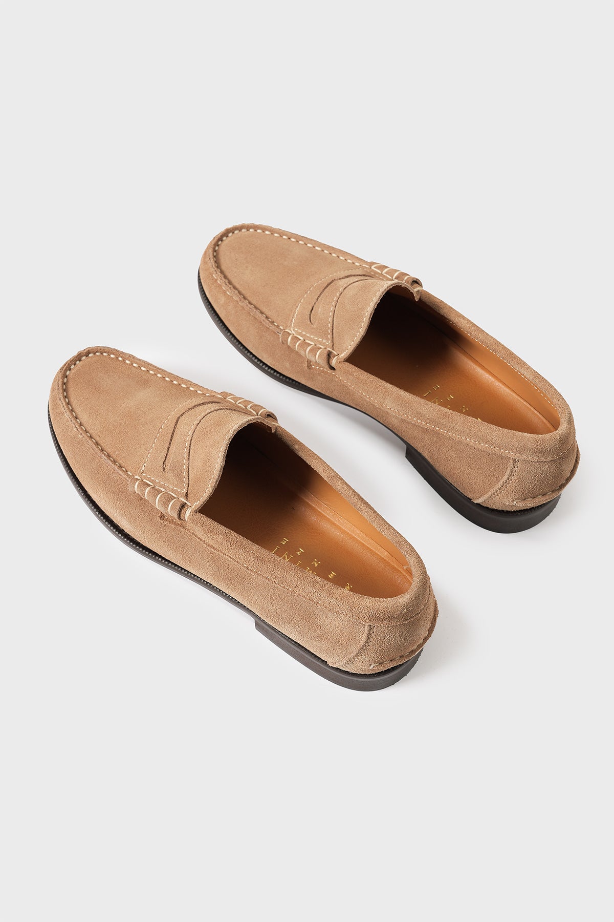 Overhead perspective view of men's chamois-coloured suede loafers