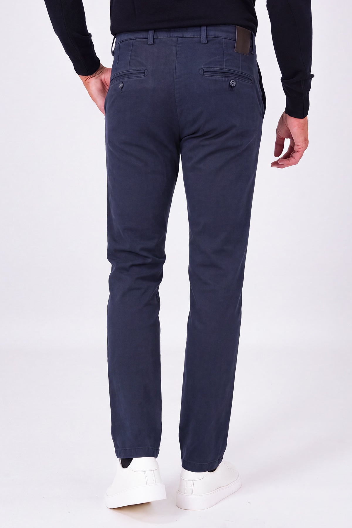 Rear view of blue stretch cotton trousers on a model