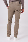 Back view of mud brown stretch cotton trousers on a model