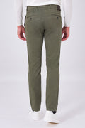 Back view of military green stretch cotton trousers on a model, with welt pockets