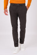 Dark brown stretch cotton trousers on a model, front view