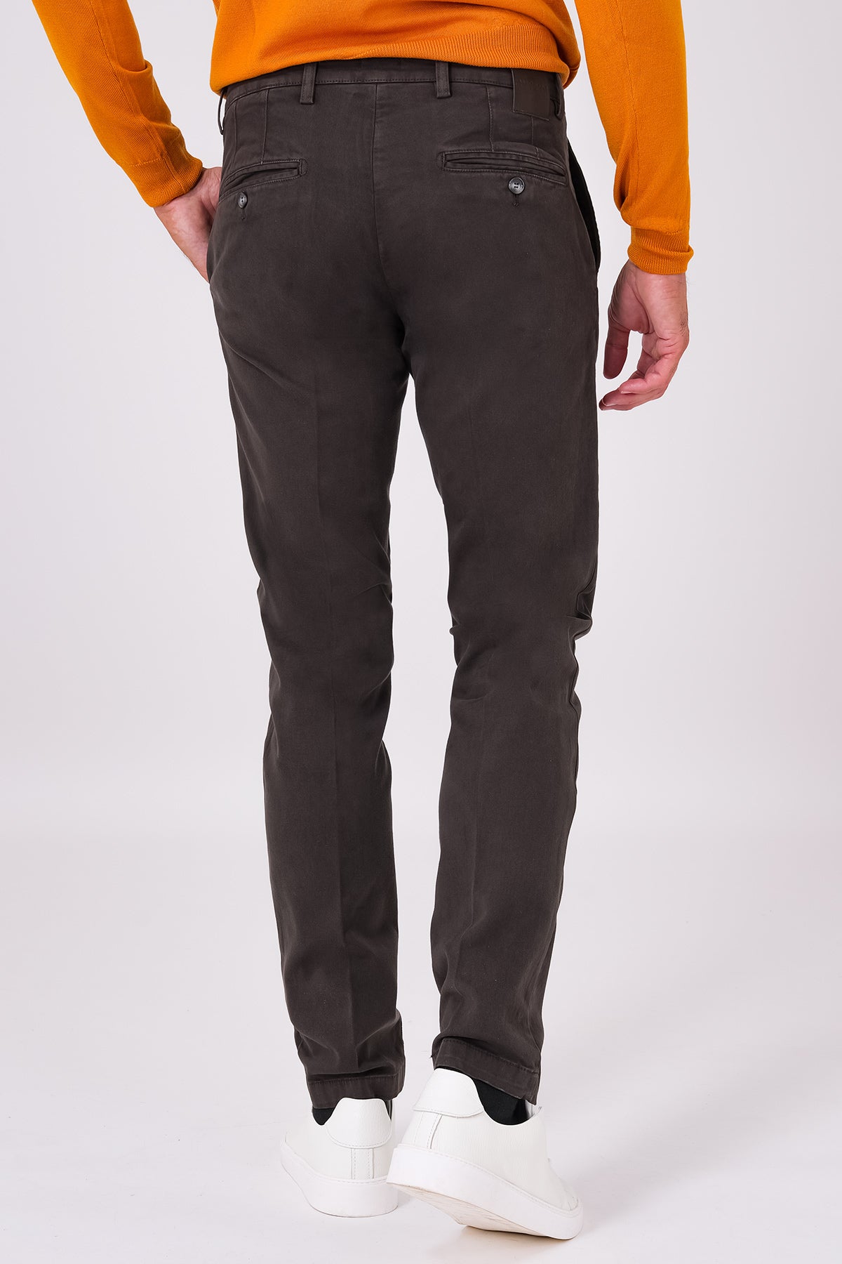 Rear view of dark brown stretch cotton trousers on a model